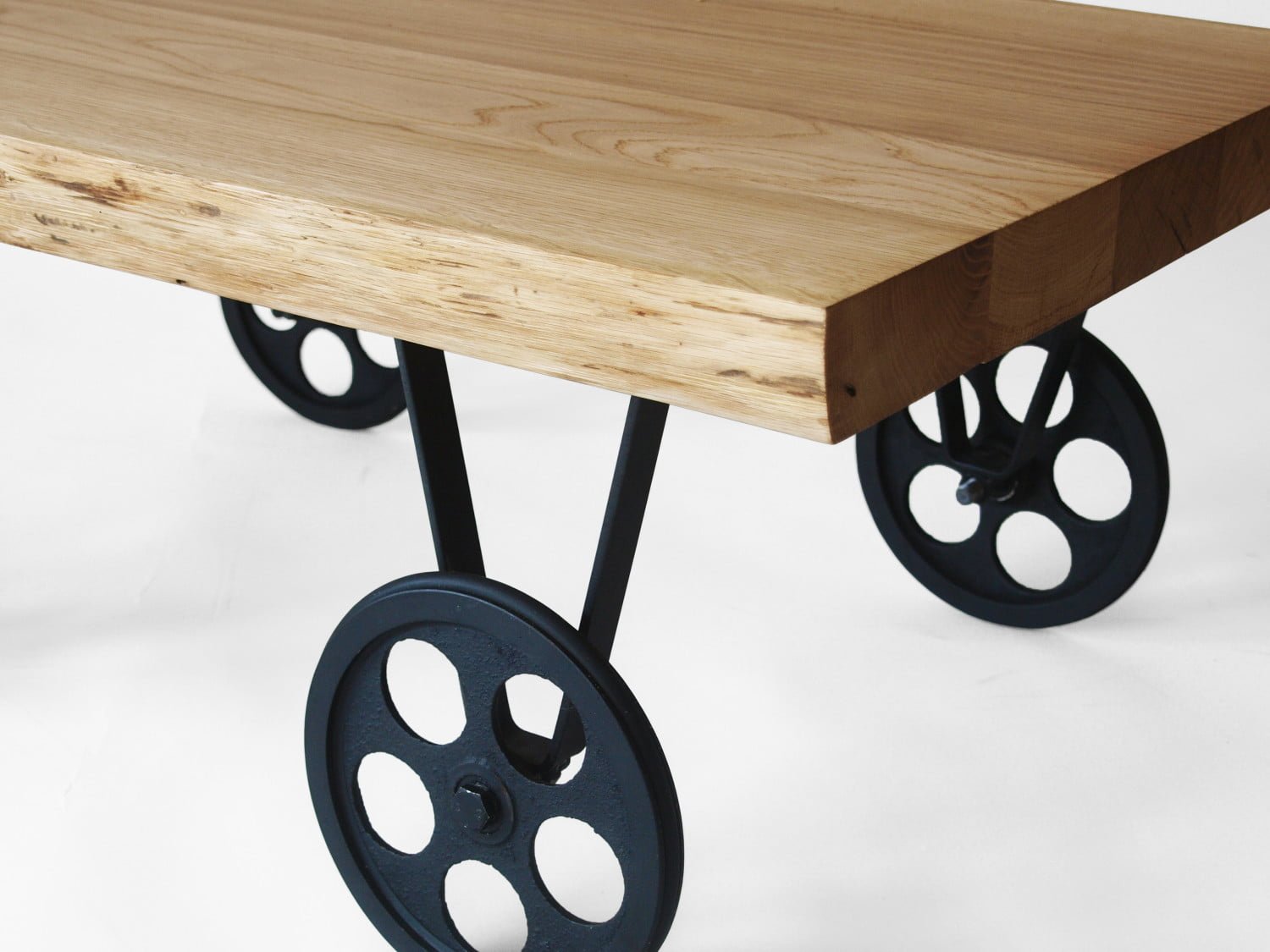 TOLIK 01 oak coffee table on black metal wheels in an industrial style